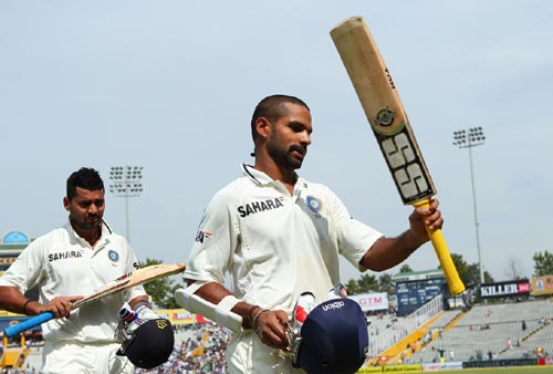 Shikhar Dhawan and Murali Vijay acknowledge the cheers from the Mohali crowd after their record opening stand, March 16, 2013. Photograph: BCCI