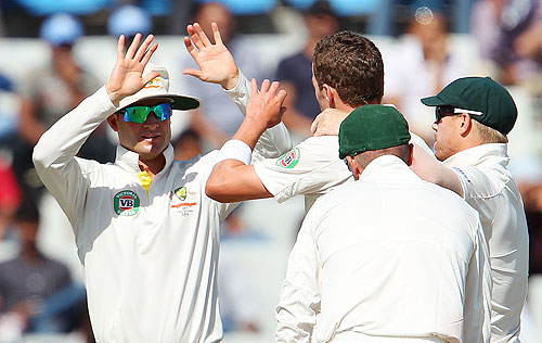 Michael Clarke and Peter Siddle celebrate a wicket during India's innings