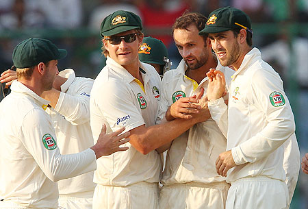 Nathan Lyon celebrates a wicket with teammates