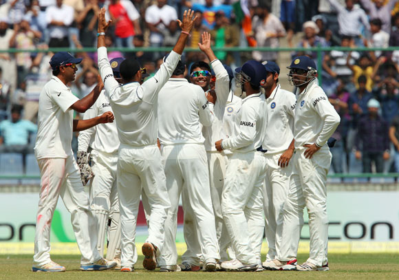 Dhoni and Pujara being congratulated by Australian players