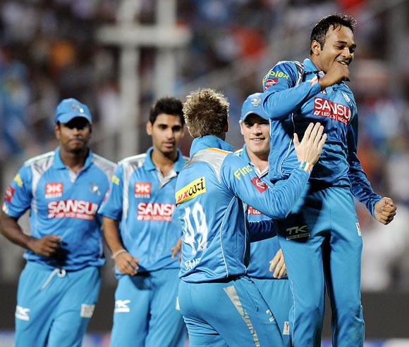 T Suman (right) celebrates with team mates after taking the wicket of Chris Gayle