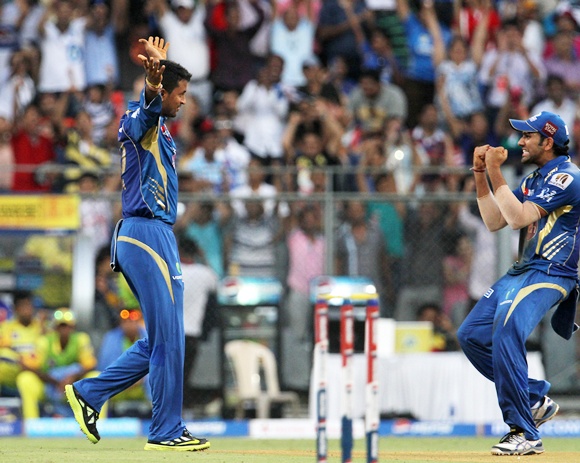 Pragyan Ojha celebrates with Rohit Sharma after taking the wicket of Michael Hussey