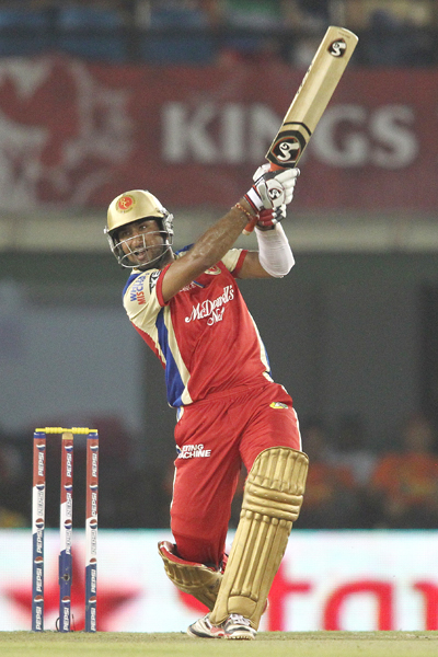 Cheteshwar Pujara of the Royal Challengers Bangalore hits over the top for a boundary