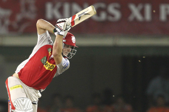 David Miller of Kings XI Punjab drives a delivery towards the boundary