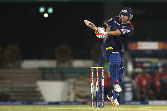 David Warner of Delhi Daredevils drives a delivery through to the boundary