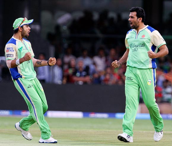 Zaheer Khan (right) celebrates with Virat Kohli after getting the wicket of Shaun Marsh