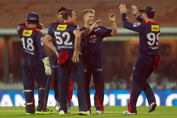 David Warner is congratulated by his teammates after taking a catch to dismiss Suresh Raina