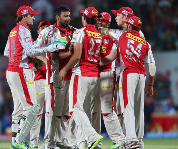 Praveen Kumar is congratulated by his teammates after taking Unmukt Chand's wicket