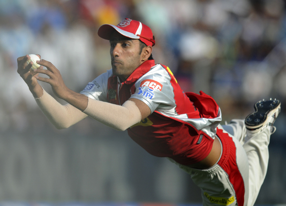 Gurkeerat Mann Singh of Kings XI Punjab dives to take a catch and get rid of Ross Taylor of Pune Warriors