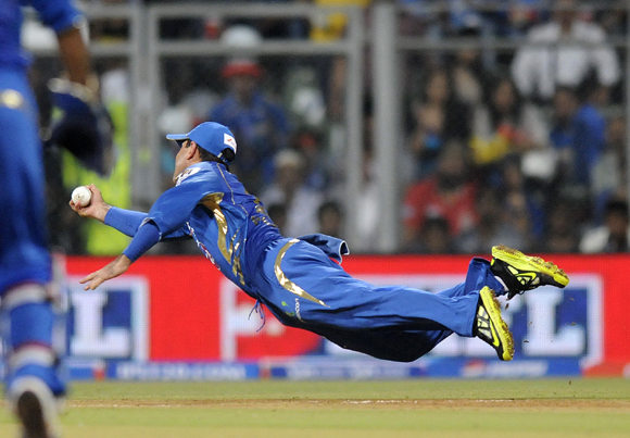 Ponting dives to his right to catch Unmukt Chand