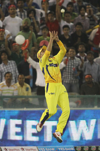 Michael Hussey leaps to take the catch and get rid of Manan Vohra of Kings XI
