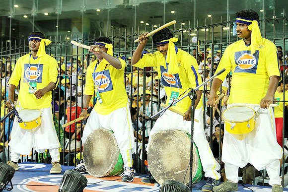 Performers go drumming during an IPL match
