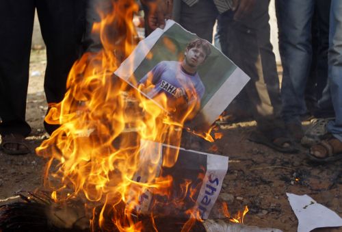 Demonstrators in Ahmedabad burn a poster of Shanthakumaran Sreesanth after the spot-fixing scandal became public