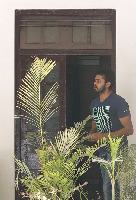 Sreesanth stands at the Delhi police crime branch office before being taken to the court