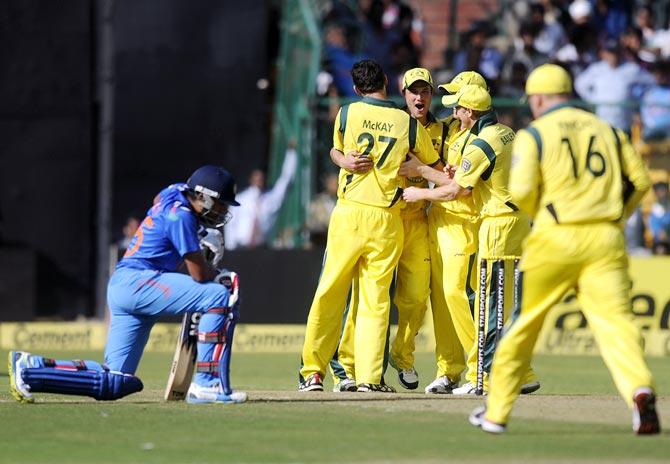 Australian players celebrate after the run out of Virat Kohli