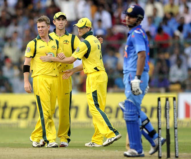 Xavier Doherty (left) celebrates with his team mates after getting the wicket of Suresh Raina