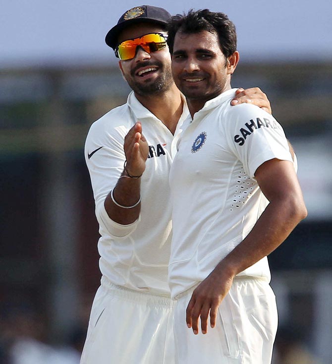 Mohammed Shami (right) celebrates with Virat Kohli after taking a wicket