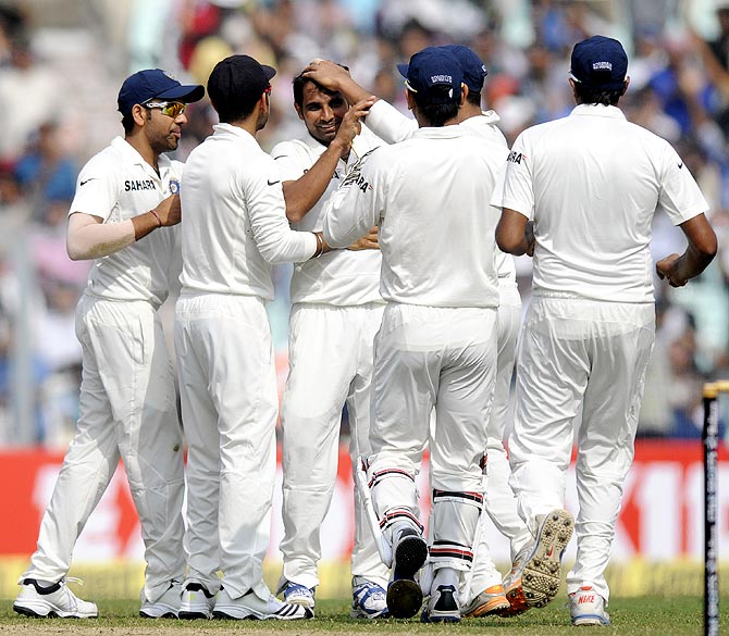 Mohammed Shami (centre) celebrates with team mates after getting the wicket of Kieran Powell