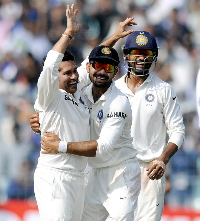 Sachin Tendulkar celebrates with the team mates after taking the wicket of Shane Shillingford
