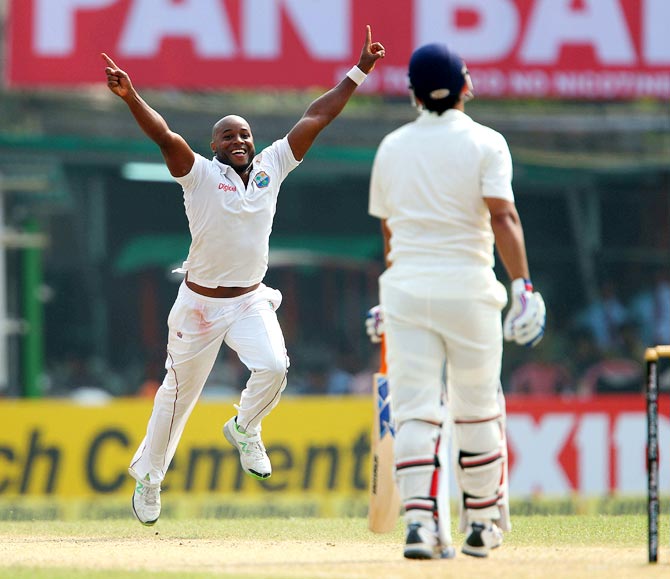Tino Best celebrates after getting the wicket of Mahendra Singh Dhoni