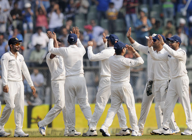 Team India celebrates the fall of a wicket