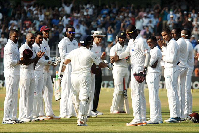 The West Indies players give Sachin Tendulkar a guard of honour as he walks out to bat at the Wankhede stadium in his farewell Test