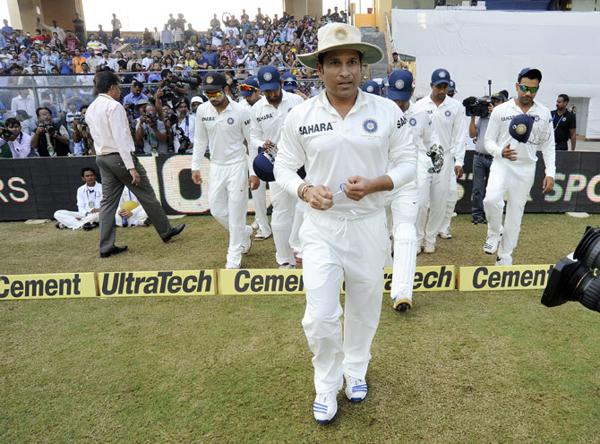 Sachin Tendulkar of India leads Team India to the middle at they walk to field during day three