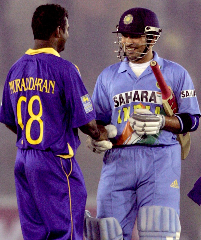 Sri Lanka's Muttiah Muralitharan (left) congratulates India's Sachin Tendulkar