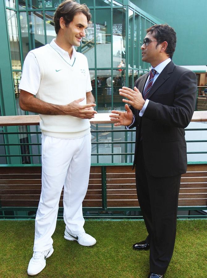 Cricket player Sachin Tendulkar (right) speaks with tennis player Roger Federer