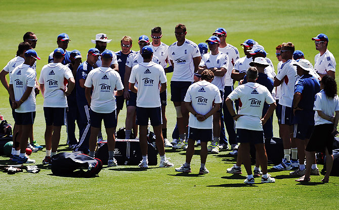 England's cricket team coach Andy Flower (left) talks with members of the team during a training session at the Gabba cricket ground in Brisbane on Thursday