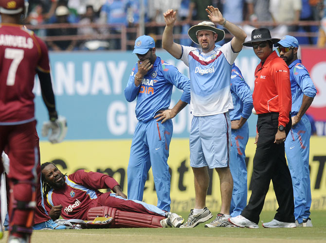 Chris Gayle of West Indies is seen in pain as he gets hurt while trying to make his crease to complete a run in Kochi