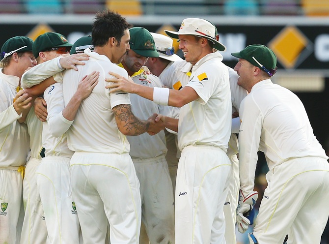 Peter Siddle of Australia shakes hands with Mitchell Johnson to celebrate victory