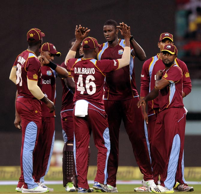 West Indies team celebrate the fall on an Indian wicket