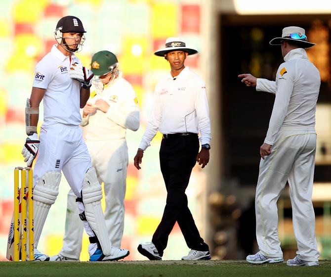 Australia captain Michael Clarke (right) speaks to James Anderson of England