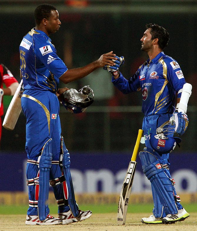 Kieron Pollard (left) and Dinesh Karthik celebrate the win