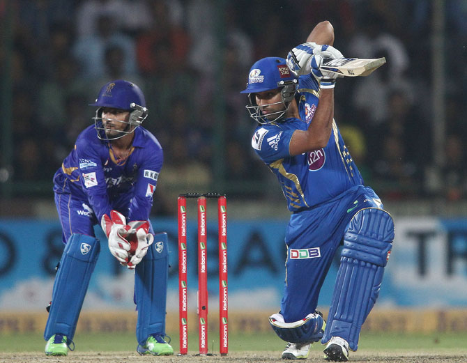 Mumbai Indians captain Rohit Sharma drives a delivery square