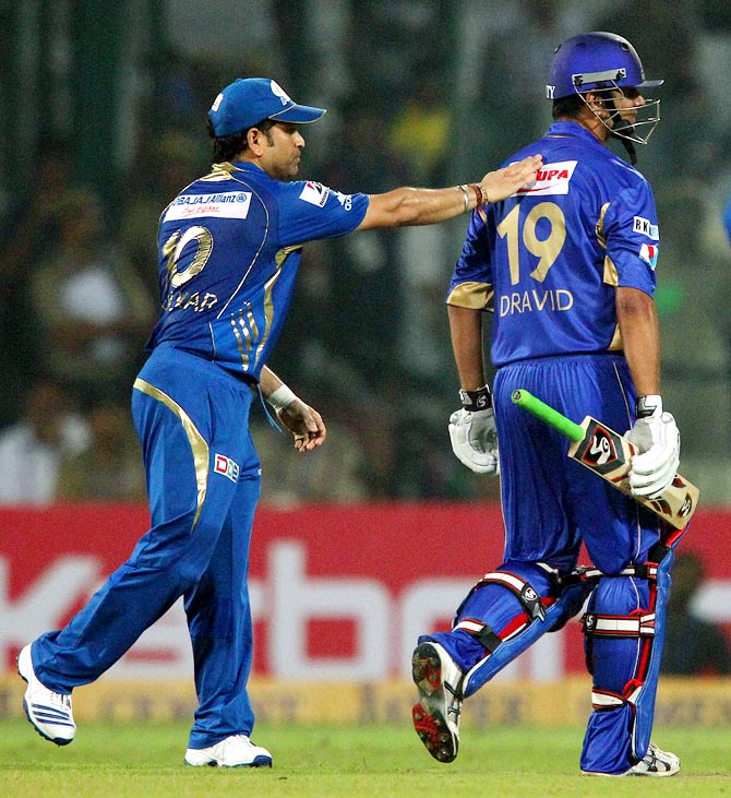 Sachin Tendulkar pats Rahul Dravid on the back after his dismissal in the Champions League T20 final