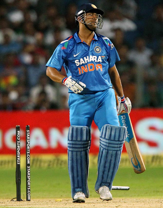 Mahendra Singh Dhoni reacts after his dismissal in the first ODI, in Pune.