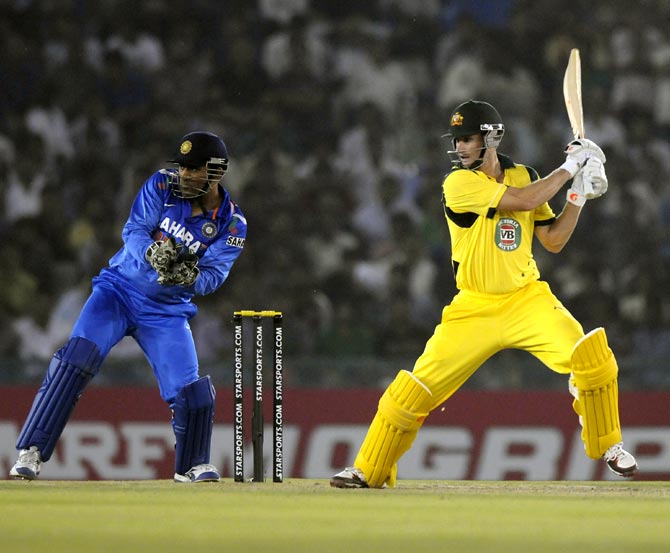 Adam Voges hits it past point as wicketkeeper Mahendra Singh Dhoni looks on