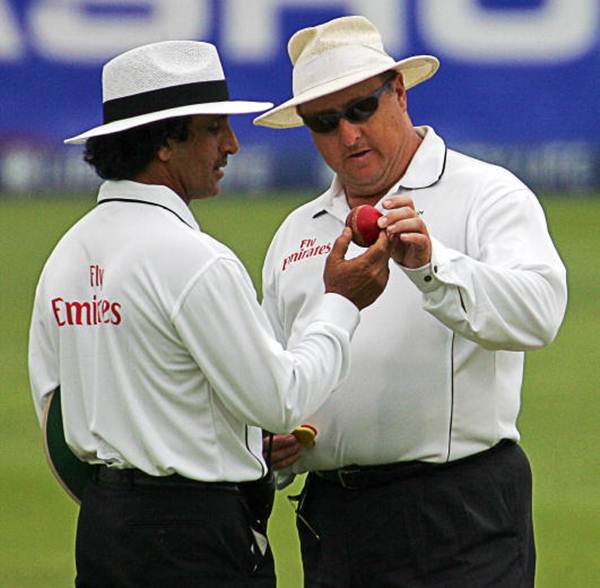 Umpires Asad Rauf (left) and Ian Howell check the ball during a match