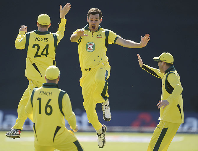 Australia's Clint McKay (2nd from right) celebrates with teammates after achieving a hat-trick after dismissing England's Joe Root on Saturday