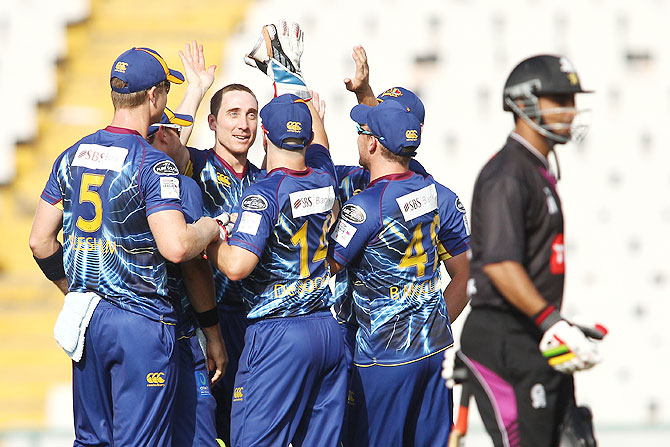 James McMillan of Otago Volts is congratulated by teammates after dismissing Ammar Mahmood Khan