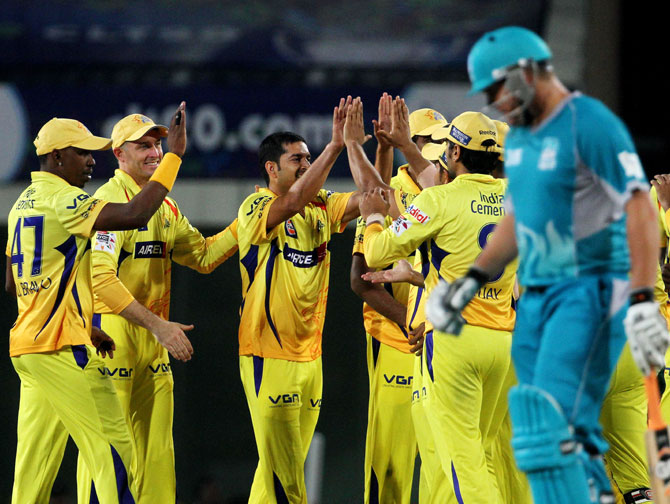 Chennai Super King players celebrate after the wicket of Brisbane Heat player Dominic Michael