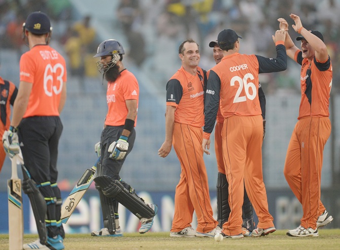 Peter Borren of the Netherlands celebrates with Wesley Barresi and   Tom Cooper after dismissing Moeen Ali of England during the ICC World Twenty20 match