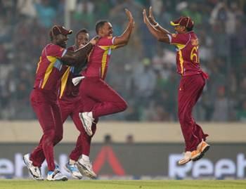 Samuel Badree of the West Indies is congratulated by Darren Sammy and his teammates after dismissing Shoaib Malik of Pakistan 