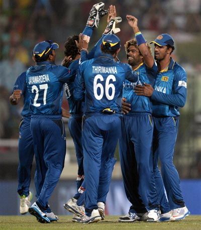 Lasith Malinga (2nd right) celebrates with team mates after dismissing West Indies opener Chris Gayle