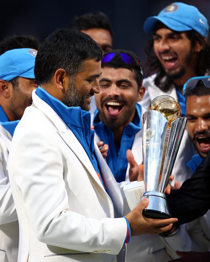 Mahendra Singh Dhoni celebrates with his team after winning the ICC Champions Trophy in June 2013.