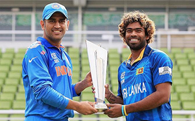 India captain MS Dhoni and Sri Lanka's Lasith Malinga with the World T20 Championship trophy in Mirpur, Dhaka on Saturday