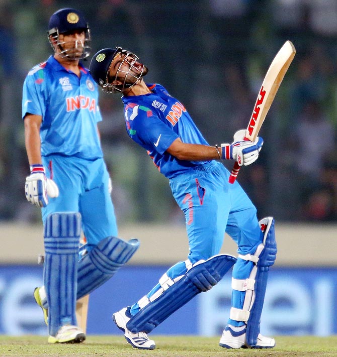 Virat Kohli (right) celebrates victory against South Africa as India captain Mahendra Singh Dhoni looks on