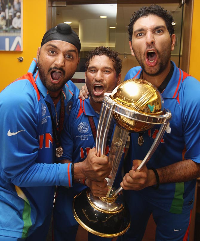 Harbhajan Singh (left),Sachin Tendulkar (centre) and Yuvraj Singh celebrate with the 2011 World Cup trophy.